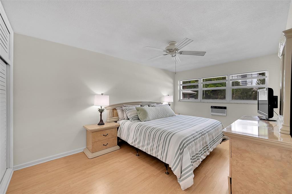 1110 North Riverside Drive, Unit 27 Pompano Beach, FL 33062 - Photo 7 of 52 Your Furnished Primary Bedroom has more than Enough Room which Includes This King Sized Bedroom Furniture and there is Still Room For a Seating, Reading or Desk Area! Includes Impact Windows & Blinds, So Peaceful!