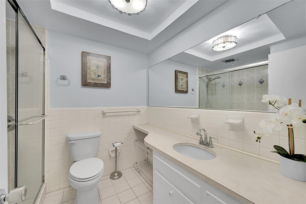 1110 North Riverside Drive, Unit 27 Pompano Beach, FL 33062 - Photo 8 of 52 Your Bathroom Has an Updated Glass Enclosed Shower, Huge Custom Mirror, Built-In Hamper, Wall Heater and lots of Storage Cabinets and Countertops.