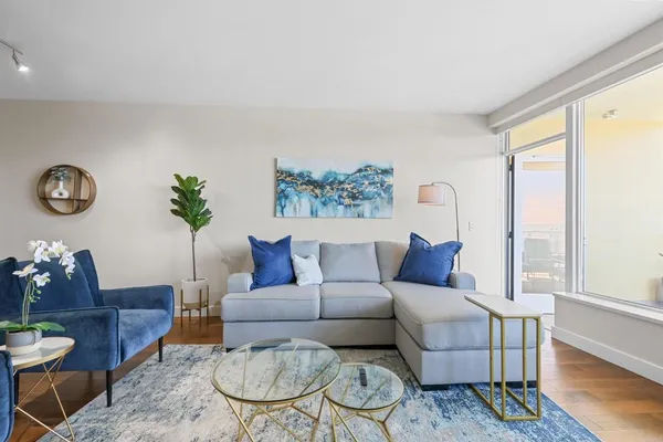 a living room with furniture and a large window