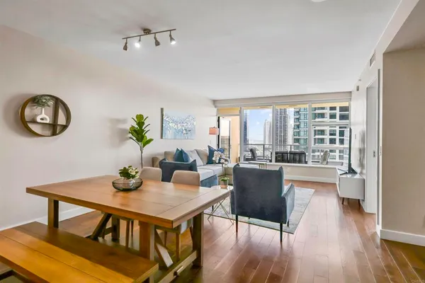 a view of a dining room with furniture window and wooden floor