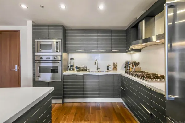 a kitchen with kitchen island stainless steel appliances a stove and refrigerator