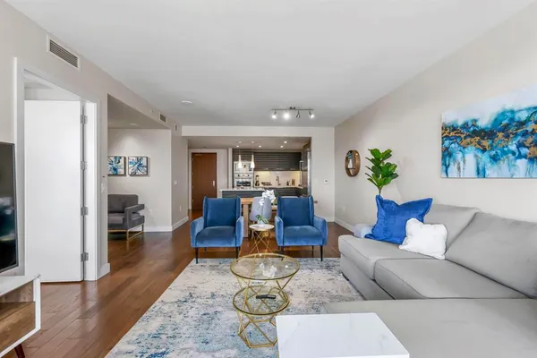 a living room with furniture and wooden floor