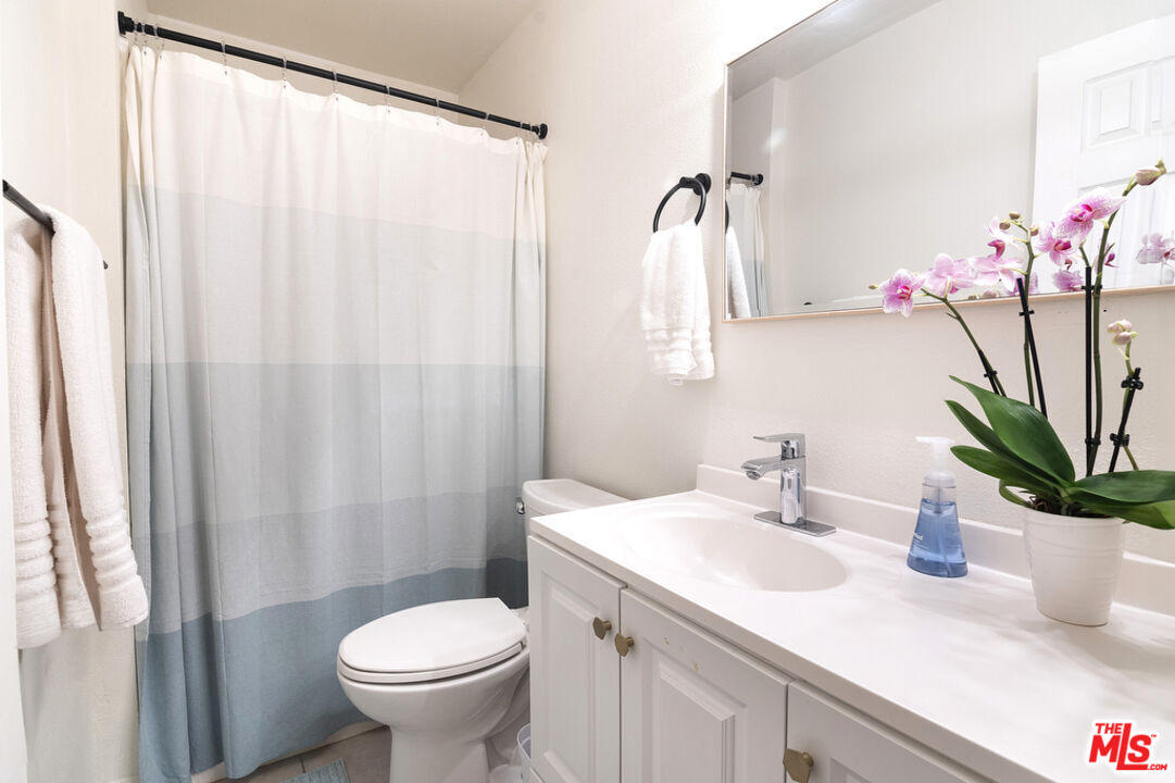 6479 Kanan Dume Road, Unit 24 Malibu, CA 90265 - Photo 15 of 22 a bathroom with a sink a toilet and a mirror