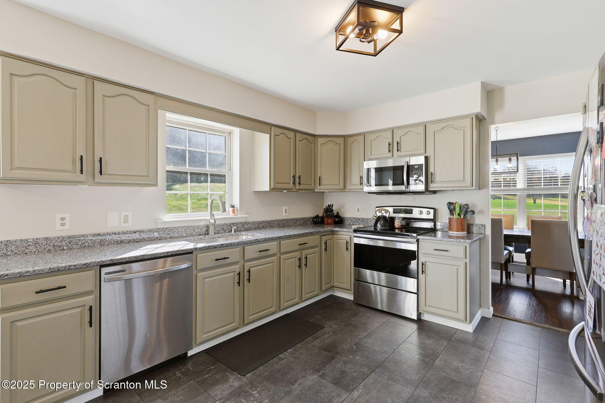 918 Jones Road Union Dale, PA 18470 - Photo 20 of 65 a kitchen with stainless steel appliances granite countertop a stove top oven a sink dishwasher and a refrigerator with wooden floor