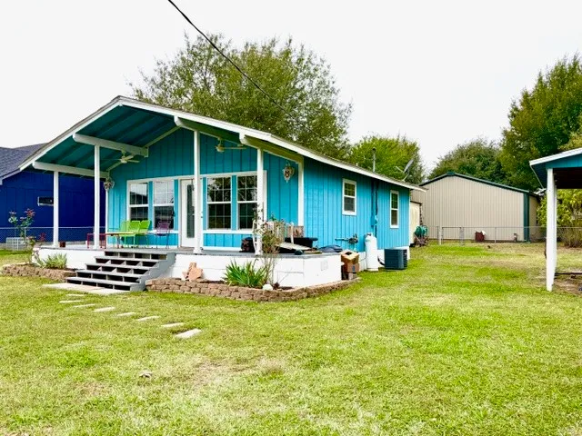 a view of a house with backyard porch and garden