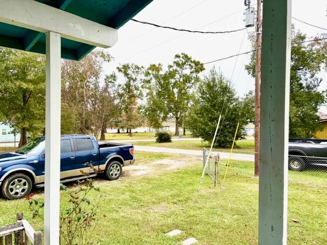a view of a porch with furniture and garden