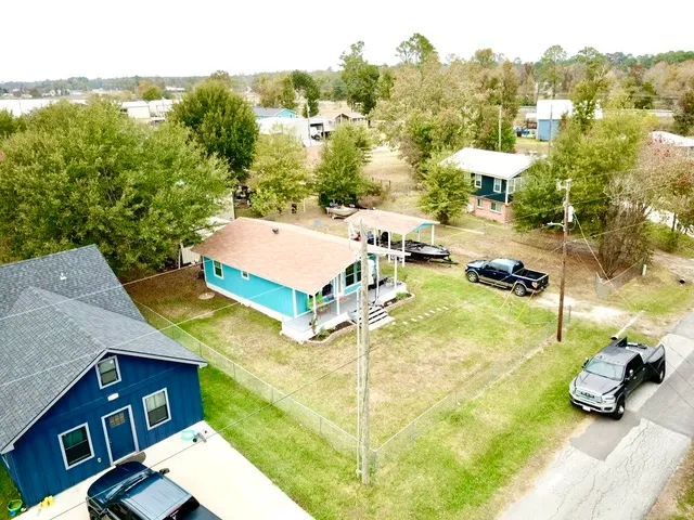 a view of a patio with table and chairs under an umbrella