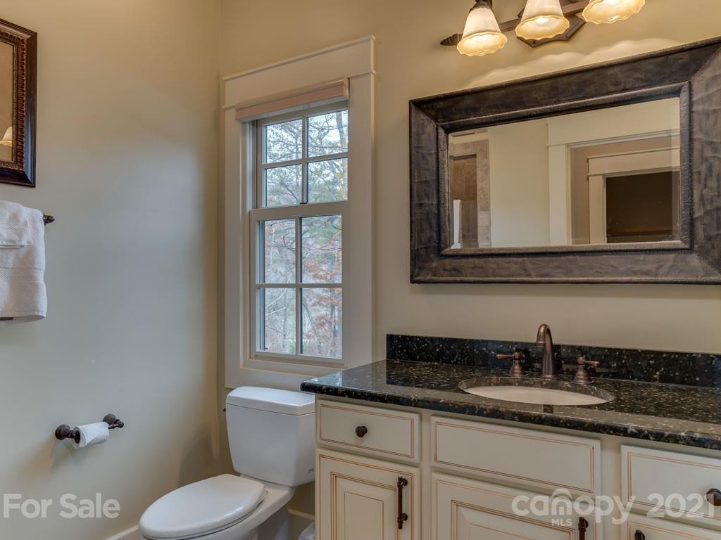 995 Deep Gap Farm Road East Mill Spring, NC 28756 - Photo 11 of 47 a bathroom with a toilet sink and mirror