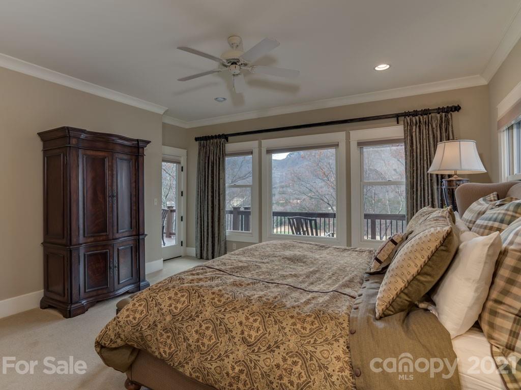 995 Deep Gap Farm Road East Mill Spring, NC 28756 - Photo 13 of 47 a bedroom with a bed and a large window