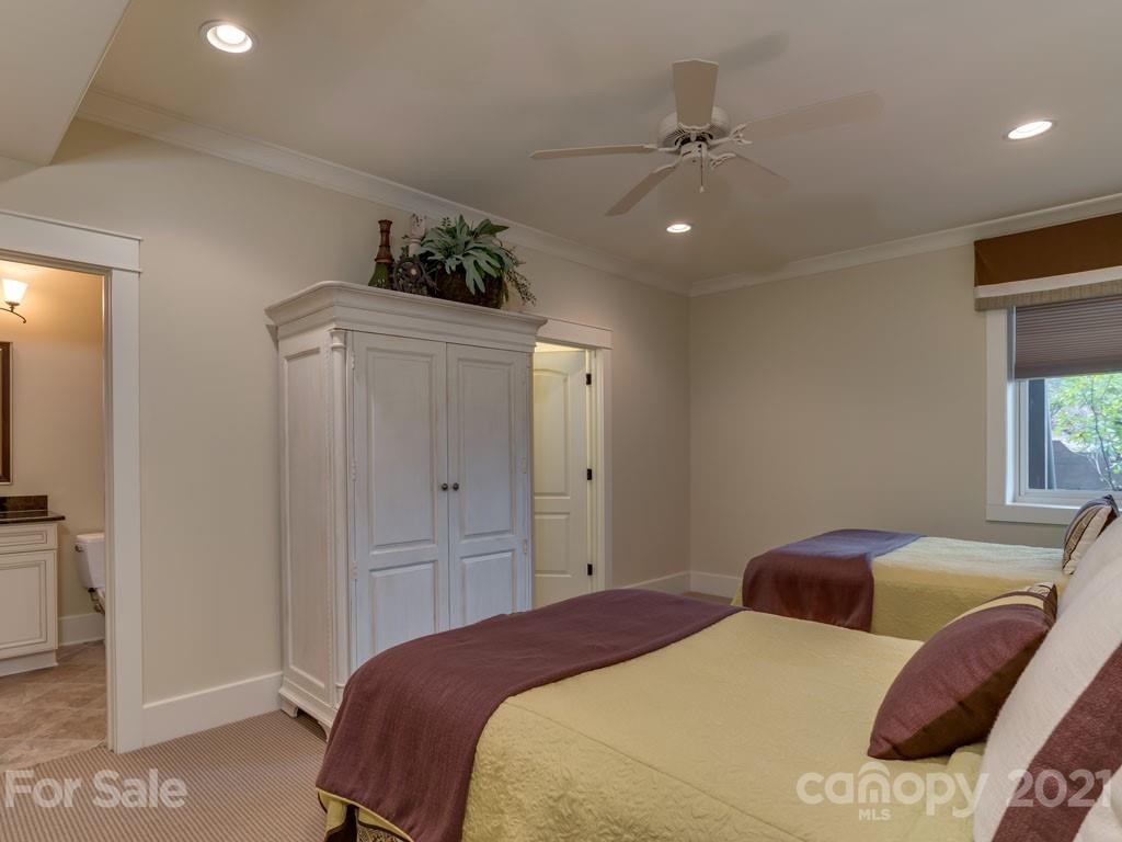 995 Deep Gap Farm Road East Mill Spring, NC 28756 - Photo 14 of 47 a bedroom with a large bed and a chandelier