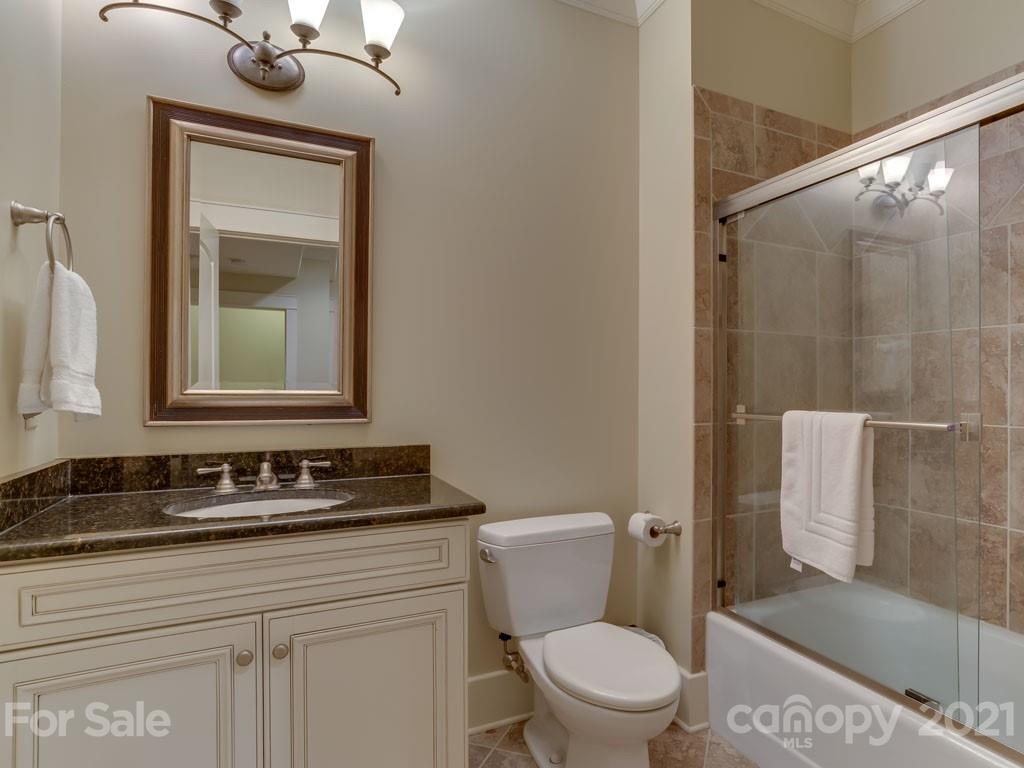 995 Deep Gap Farm Road East Mill Spring, NC 28756 - Photo 16 of 47 a bathroom with a toilet a sink and mirror