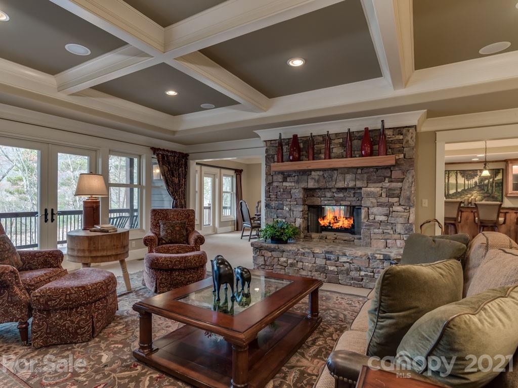 995 Deep Gap Farm Road East Mill Spring, NC 28756 - Photo 17 of 47 a living room with furniture large window and a fireplace