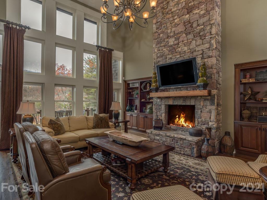 995 Deep Gap Farm Road East Mill Spring, NC 28756 - Photo 2 of 47 a living room with furniture a flat screen tv and a fireplace