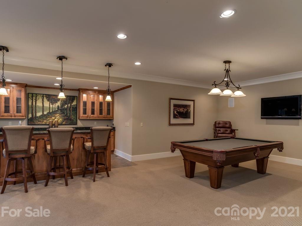 995 Deep Gap Farm Road East Mill Spring, NC 28756 - Photo 21 of 47 a living room with dining table and a chandelier