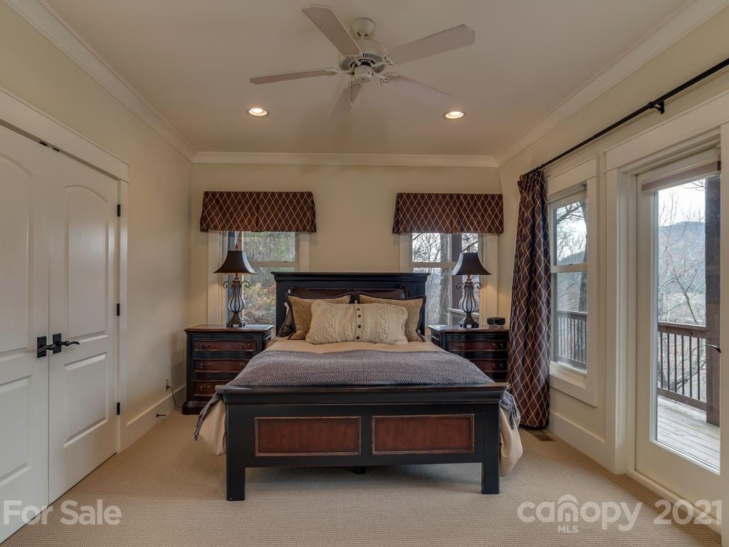 995 Deep Gap Farm Road East Mill Spring, NC 28756 - Photo 24 of 47 a bedroom with a bed lamp and window