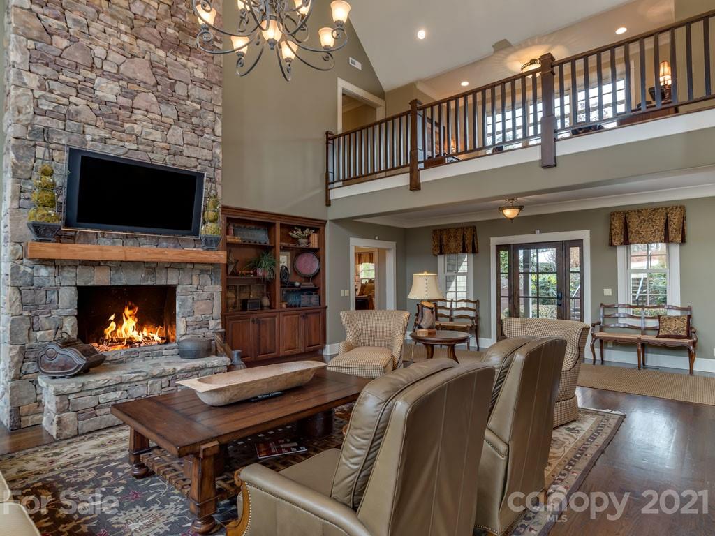 995 Deep Gap Farm Road East Mill Spring, NC 28756 - Photo 3 of 47 a living room with furniture a flat screen tv and a fireplace