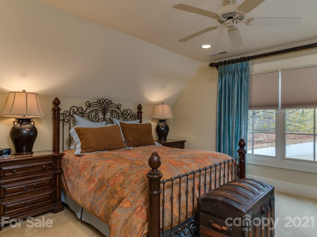 995 Deep Gap Farm Road East Mill Spring, NC 28756 - Photo 34 of 47 a bedroom with a bed and wooden floor