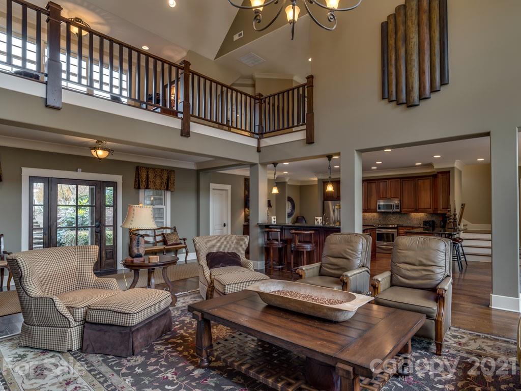 995 Deep Gap Farm Road East Mill Spring, NC 28756 - Photo 4 of 47 a living room with furniture a rug and a chandelier