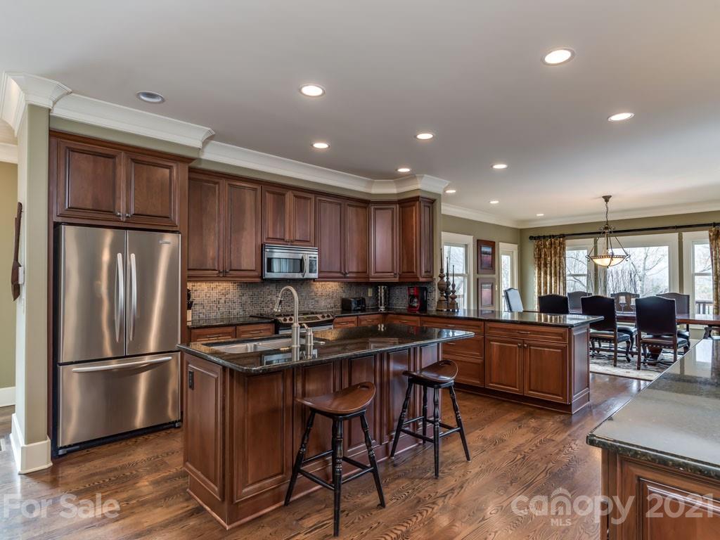995 Deep Gap Farm Road East Mill Spring, NC 28756 - Photo 7 of 47 a kitchen with refrigerator and chairs