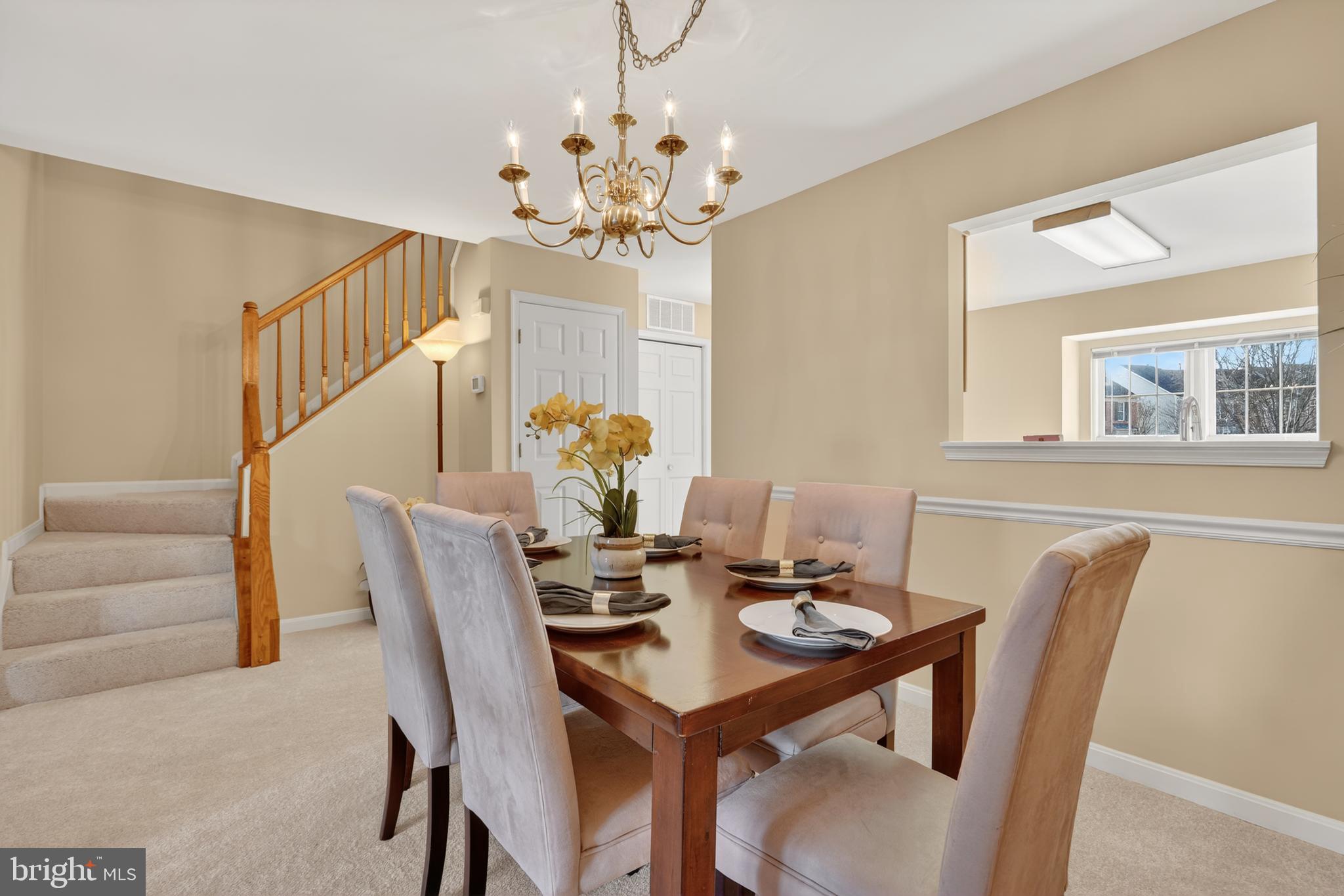 45590 Whitcomb Square Sterling, VA 20166 - Photo 13 of 43 a view of a dining room with furniture and chandelier