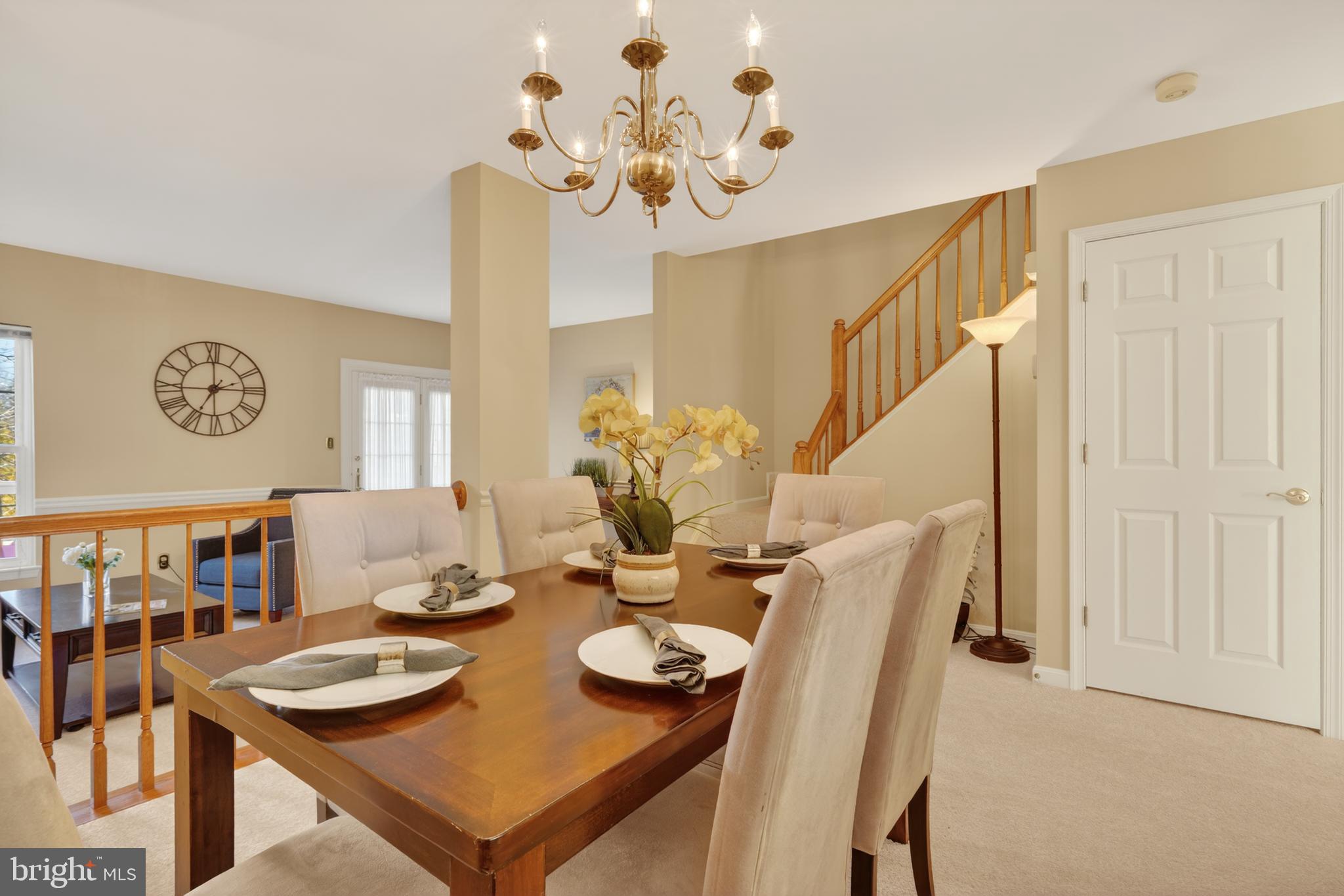 45590 Whitcomb Square Sterling, VA 20166 - Photo 14 of 43 a view of a dining room with furniture and a chandelier