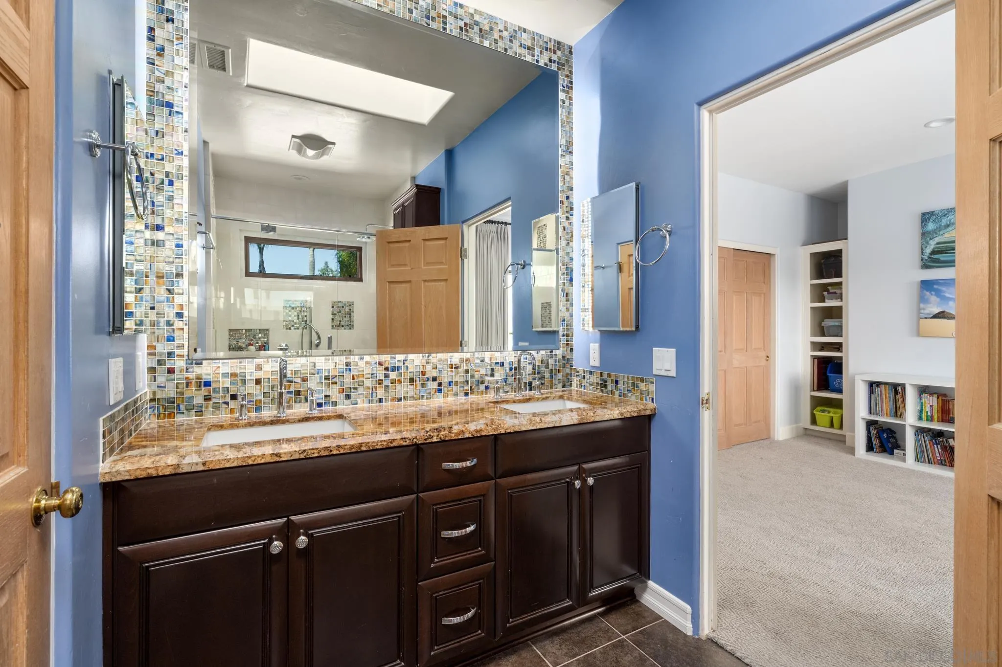3028 Paseo Cielo Rancho Santa Fe, CA 92024 - Photo 32 of 50 a bathroom with a granite countertop sink a large mirror and a shower