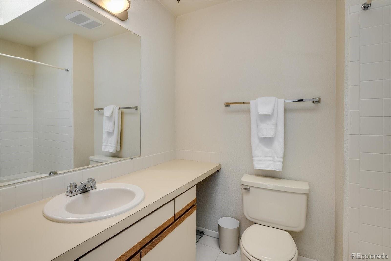 4635 Chestnut Lane, Unit 3 Boulder, CO 80301 - Photo 15 of 36 a bathroom with a toilet sink and mirror
