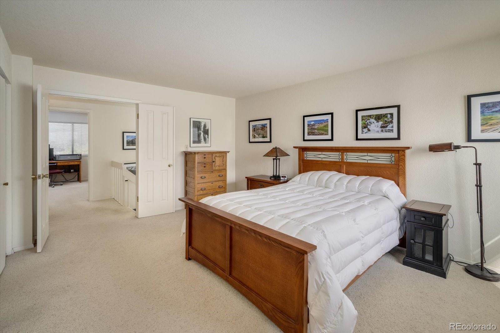 4635 Chestnut Lane, Unit 3 Boulder, CO 80301 - Photo 16 of 36 a bedroom with a large bed and dresser