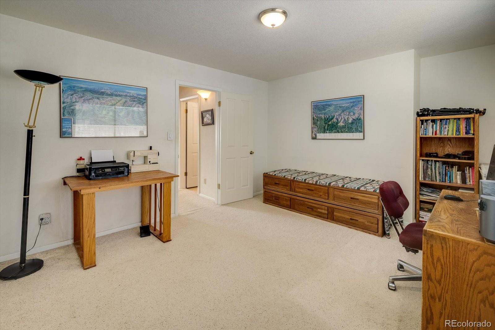 4635 Chestnut Lane, Unit 3 Boulder, CO 80301 - Photo 18 of 36 a living room with furniture and a book shelf