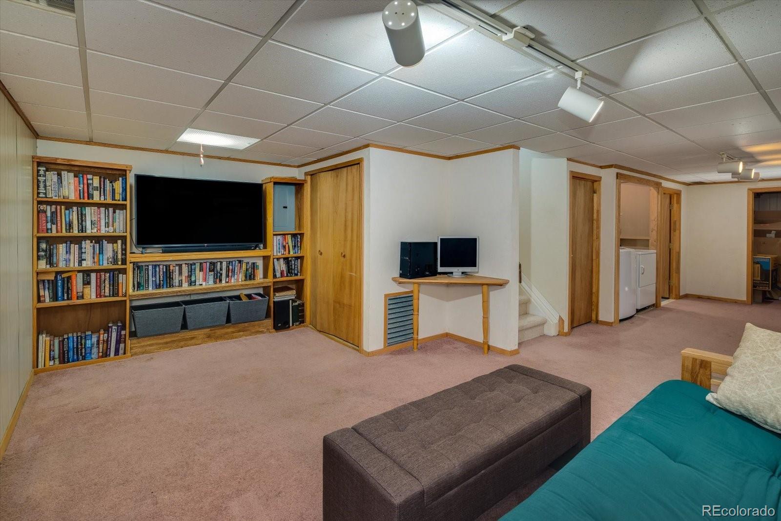 4635 Chestnut Lane, Unit 3 Boulder, CO 80301 - Photo 21 of 36 a living room with furniture and a flat screen tv