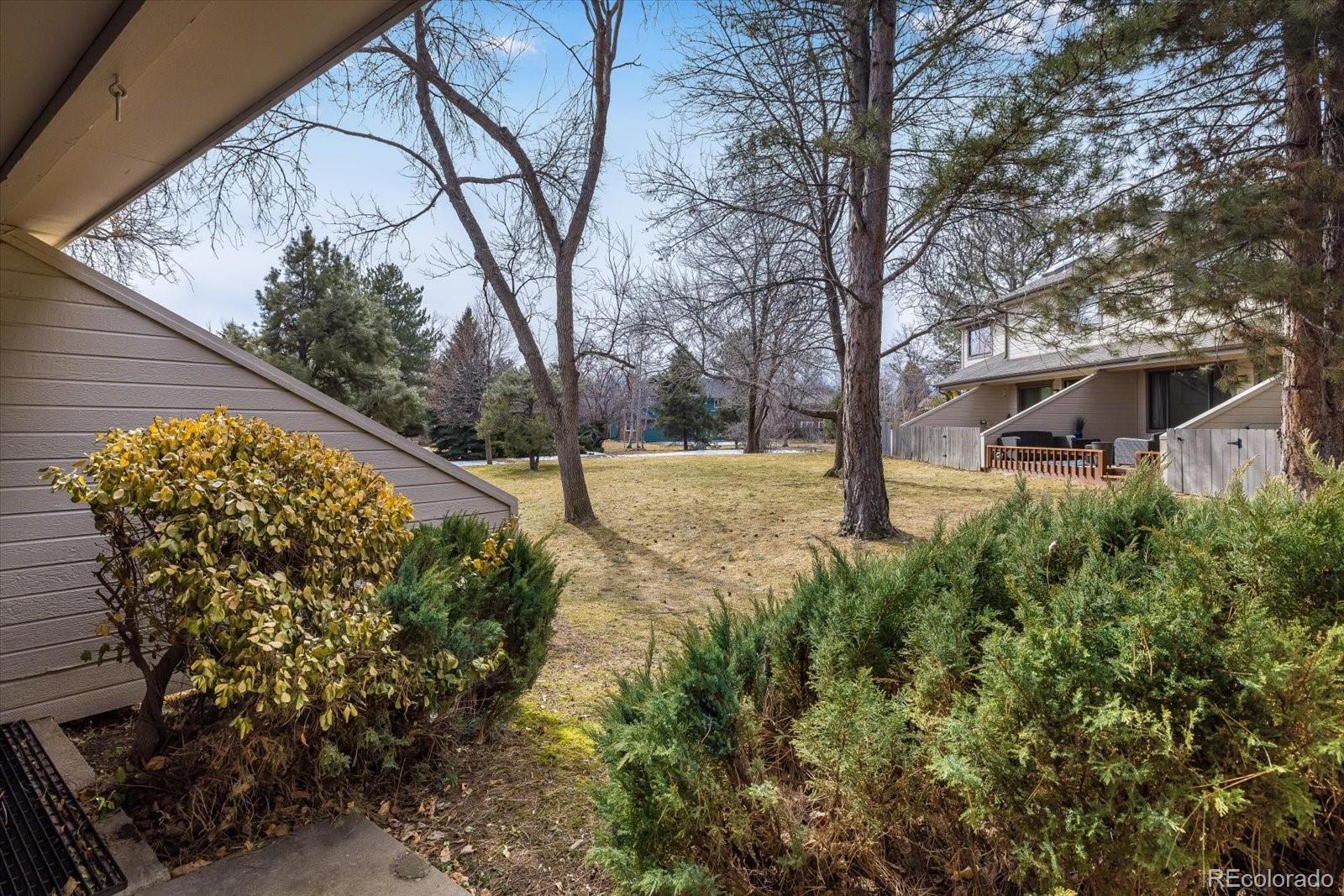 4635 Chestnut Lane, Unit 3 Boulder, CO 80301 - Photo 24 of 36 a view of a yard with plants and large trees