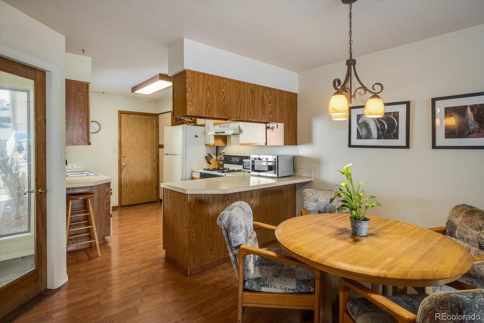 4635 Chestnut Lane, Unit 3 Boulder, CO 80301 - Photo 8 of 36 a view of a dining room with furniture and wooden floor