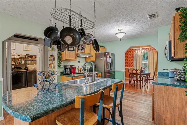 an outdoor space with furniture and view of kitchen