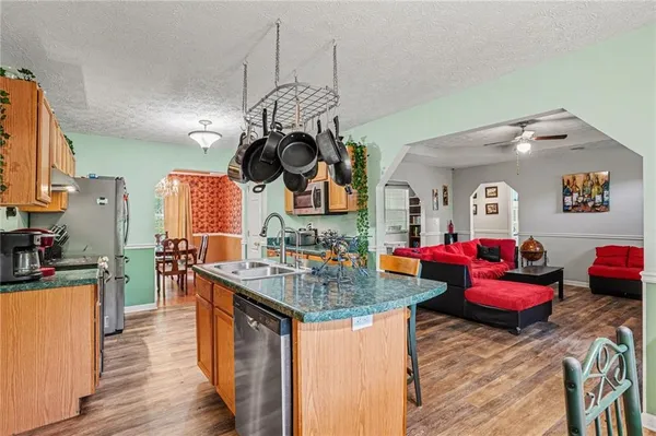 a kitchen with stainless steel appliances granite countertop a stove and a sink