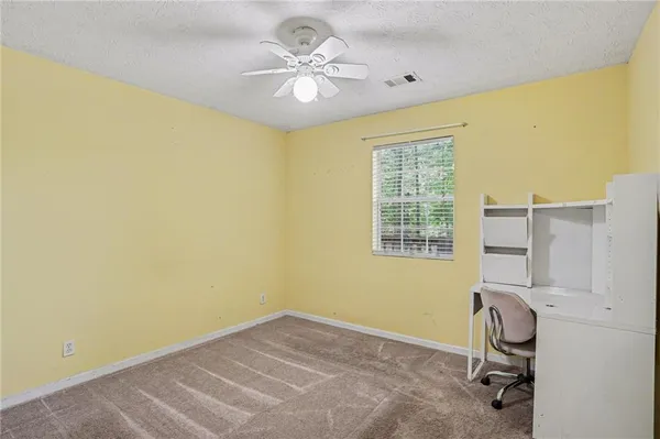 a view of an empty room with a fan