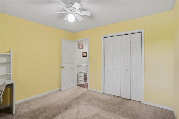 a bathroom with a granite countertop toilet sink and mirror