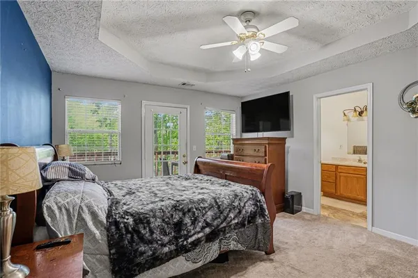 a bedroom with a bed dresser and a window
