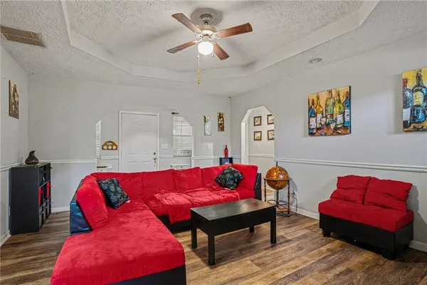a living room with furniture and wooden floor
