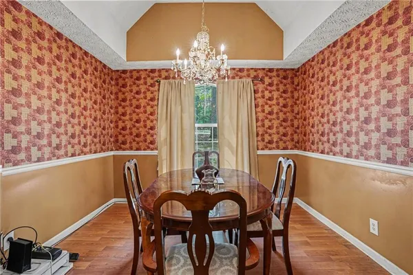 a view of a dining room with furniture and chandelier