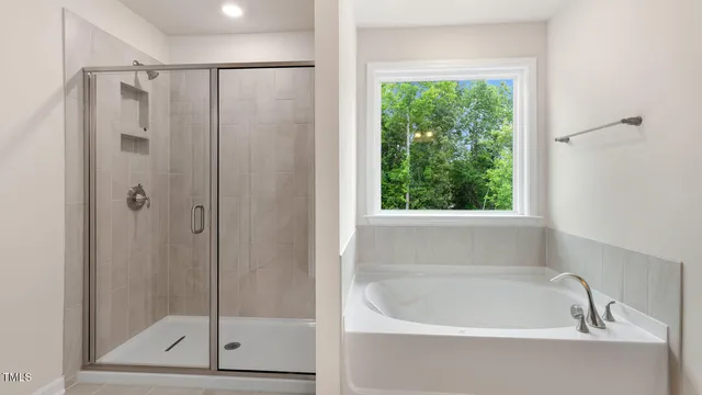 a bathroom with a bathtub and shower