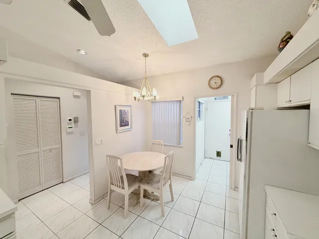 a spacious bathroom with a glass shower door and a window