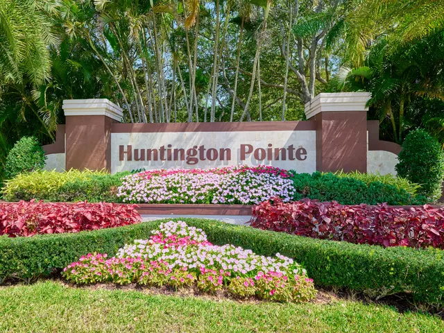 a sign that is sitting in front of flowers