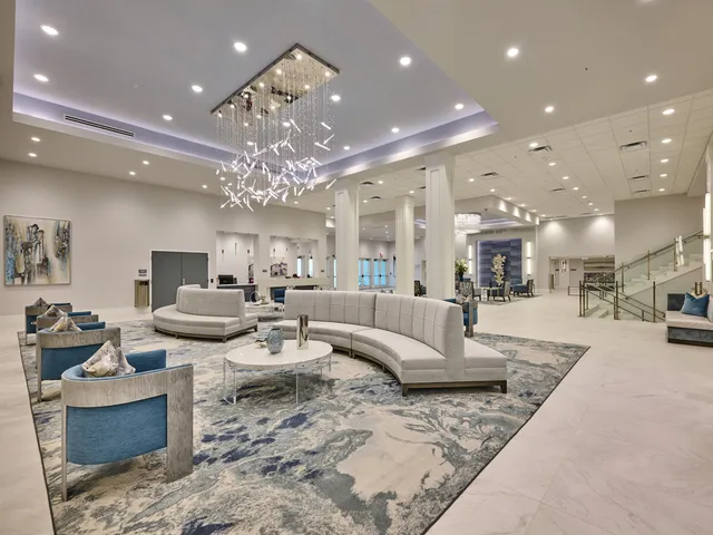 a living room with fireplace furniture and a chandelier