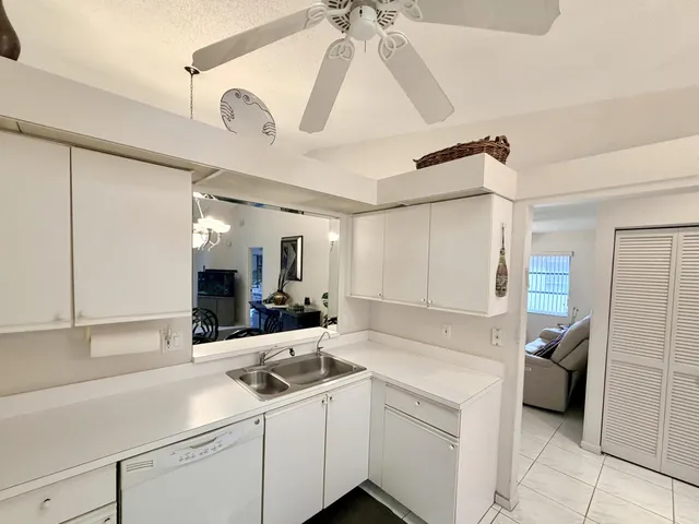 a kitchen with a sink cabinets and appliances