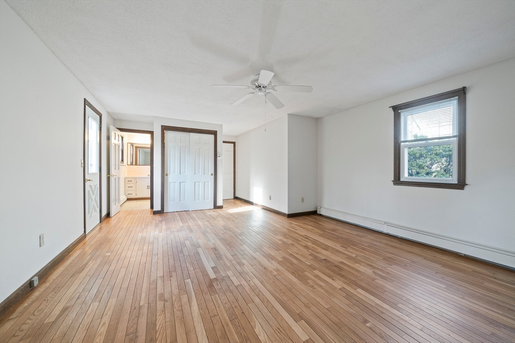 33 Oak Ridge Road Sandwich, MA 02537 - Photo 14 of 42 a view of an empty room with a window and wooden floor
