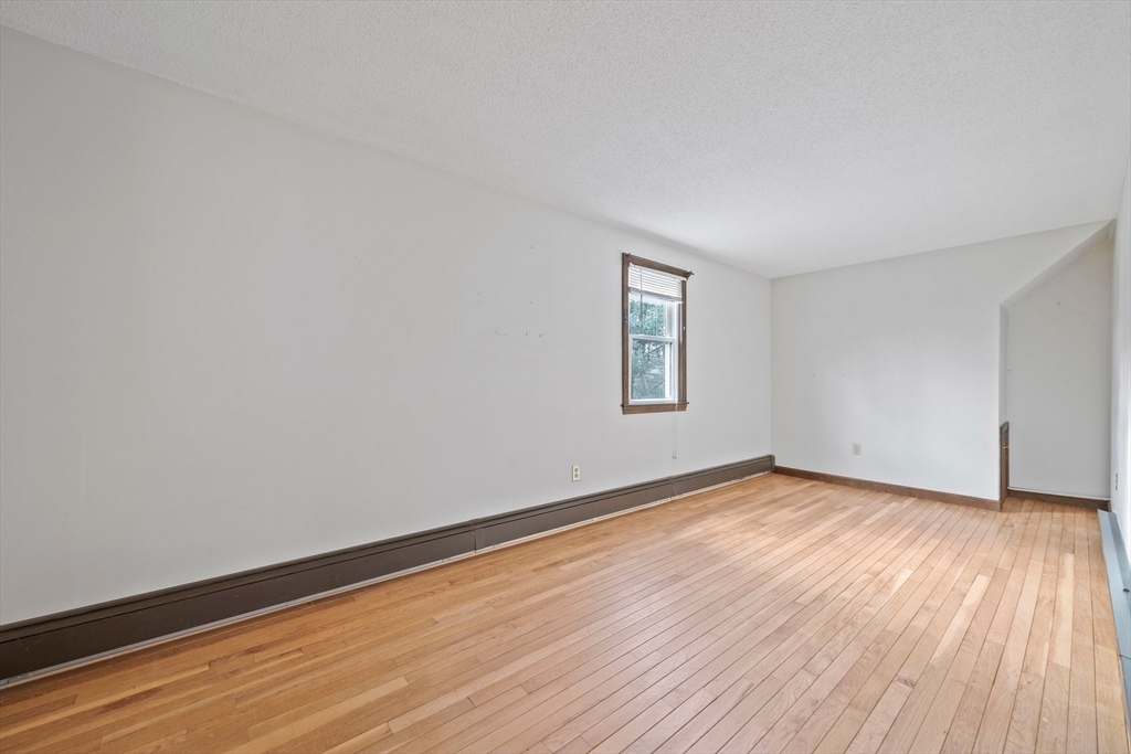 33 Oak Ridge Road Sandwich, MA 02537 - Photo 22 of 42 an empty room with wooden floor and windows