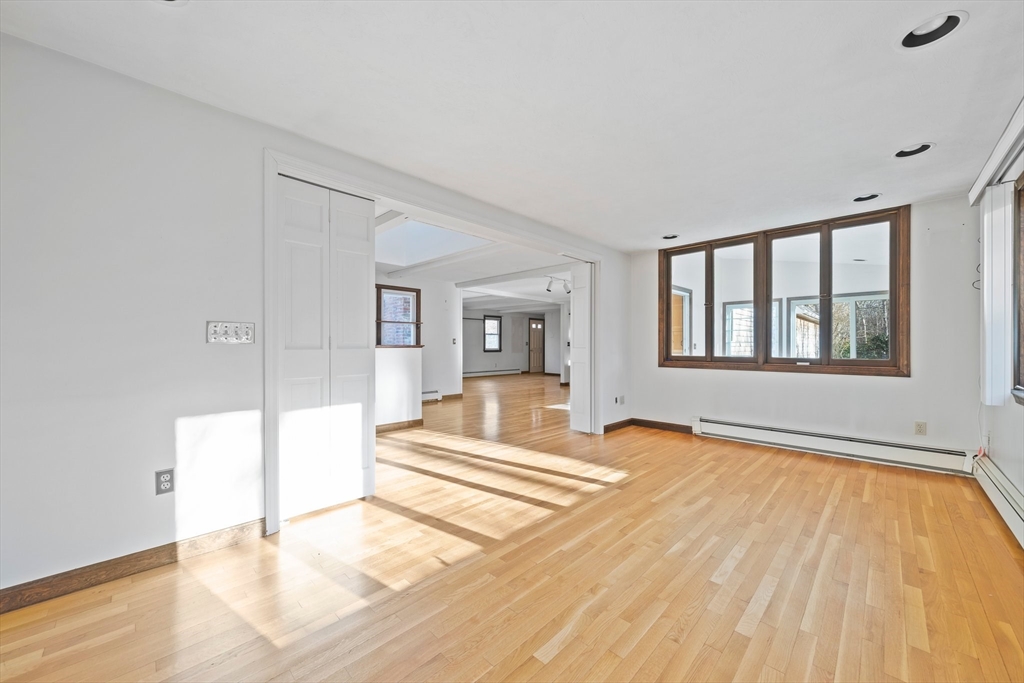 33 Oak Ridge Road Sandwich, MA 02537 - Photo 6 of 42 a view of an empty room with wooden floor and a window