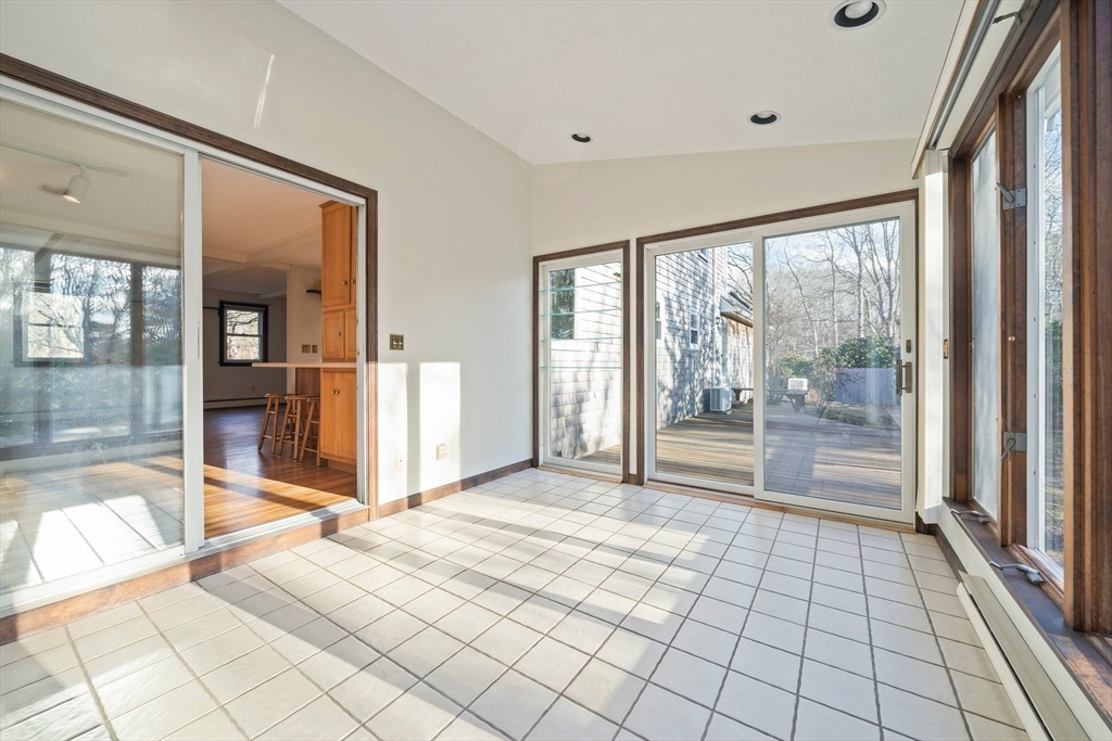 33 Oak Ridge Road Sandwich, MA 02537 - Photo 9 of 42 a view of empty room with wooden floor and large windows