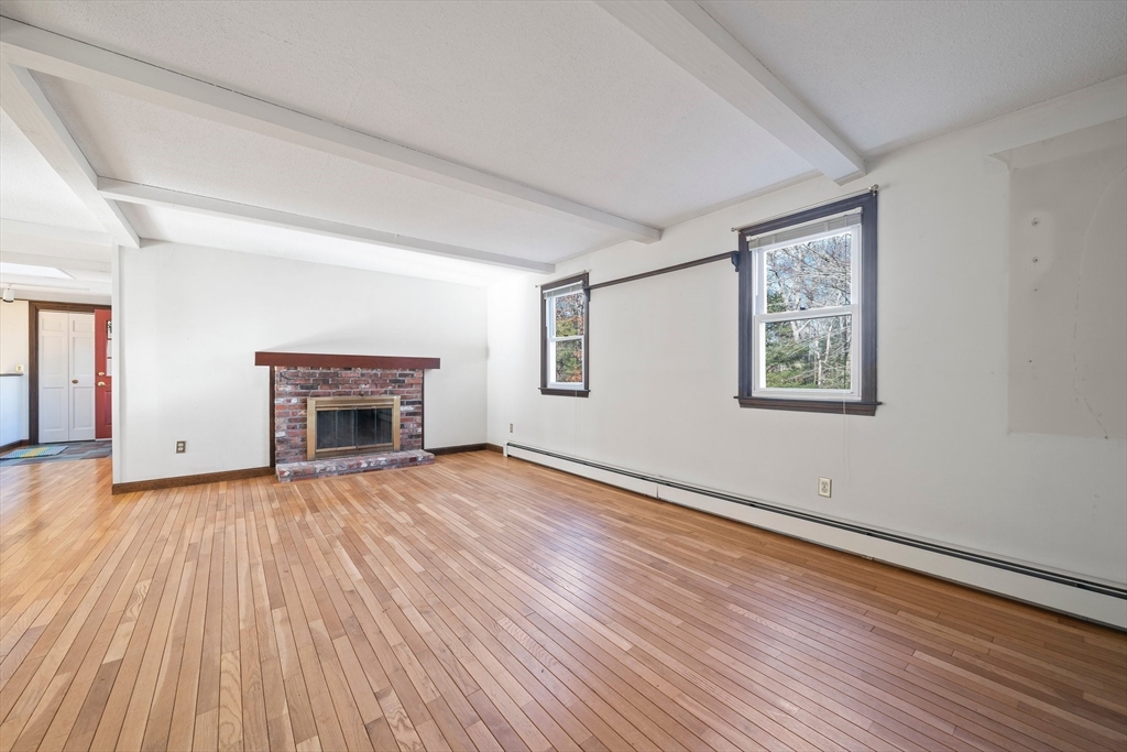 33 Oak Ridge Road Sandwich, MA 02537 - Photo 10 of 42 a view of empty room with wooden floor and fireplace