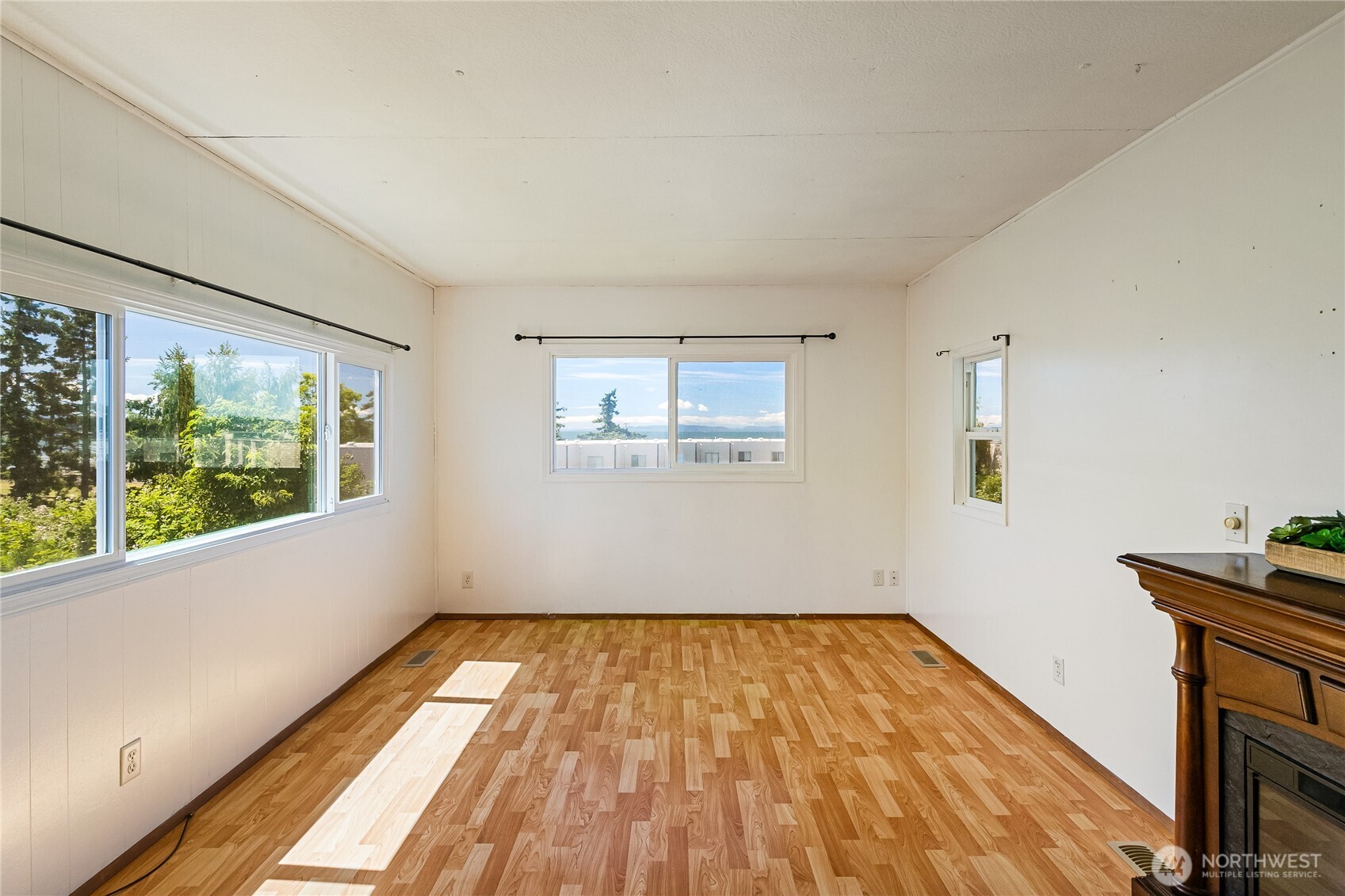 8080 Harborview Road, Unit 167 Blaine, WA 98230 - Photo 9 of 27 a view of empty room with wooden floor and fan